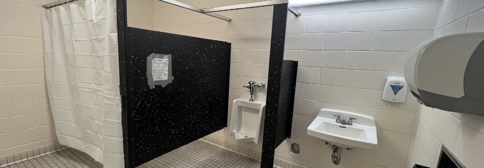 Various important supplies are missing from the boys F-hallway bathroom. In lieu of the missing stall door, some students installed a shower curtain in order to return the stall to being usable.